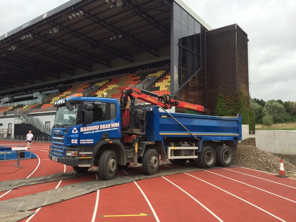 a large blue truck parked on top of a track