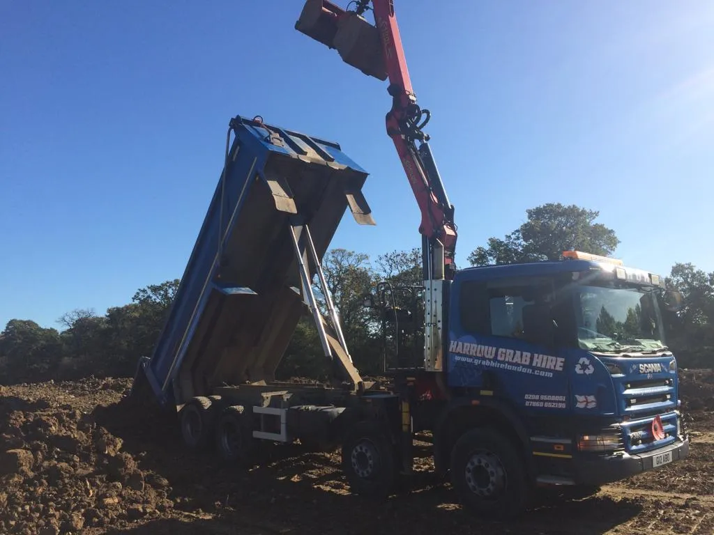 a blue dump truck with a crane on top of it