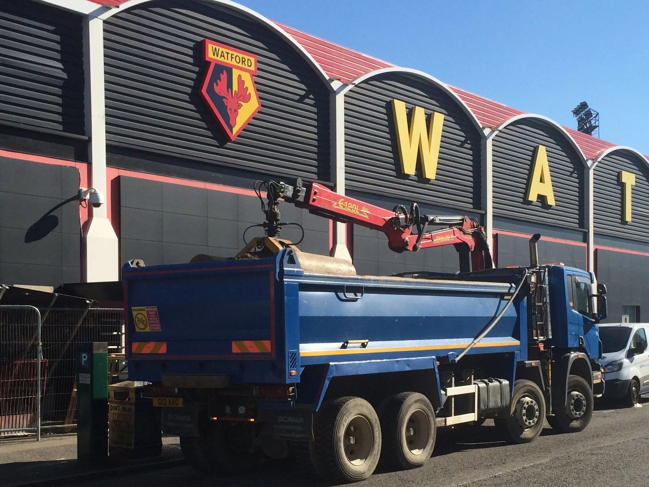 a blue truck parked in front of a building